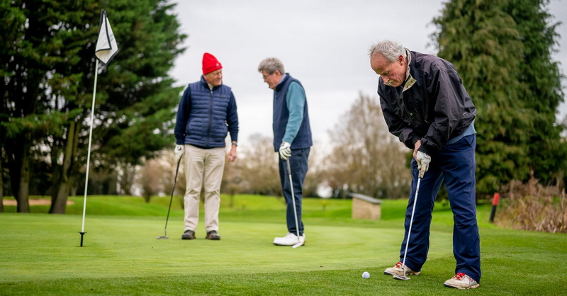 3 golf players on the grass